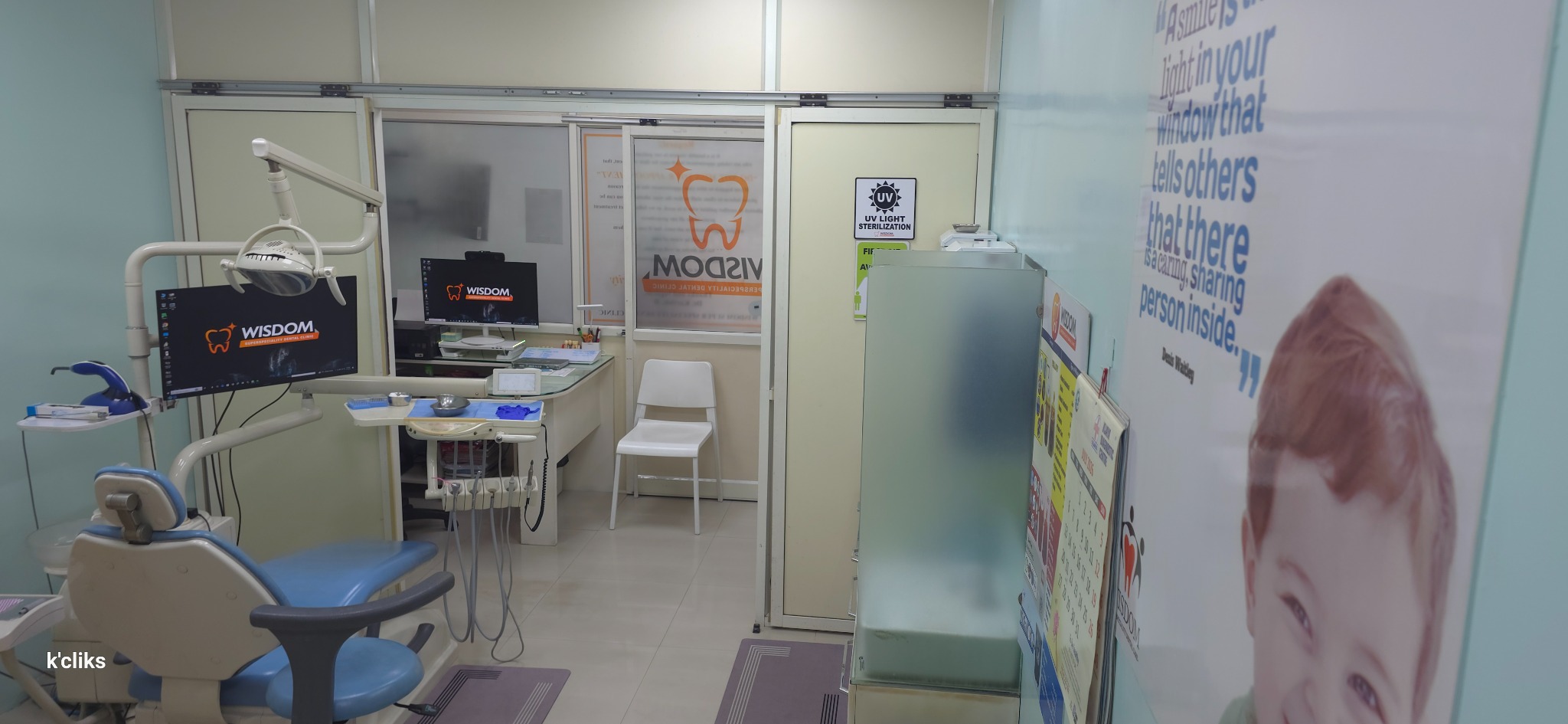 Dental treatment room with chair, monitor and clinical equipment